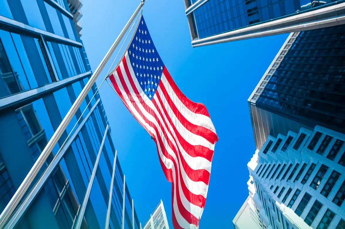 The American flag flying between downtown towers
