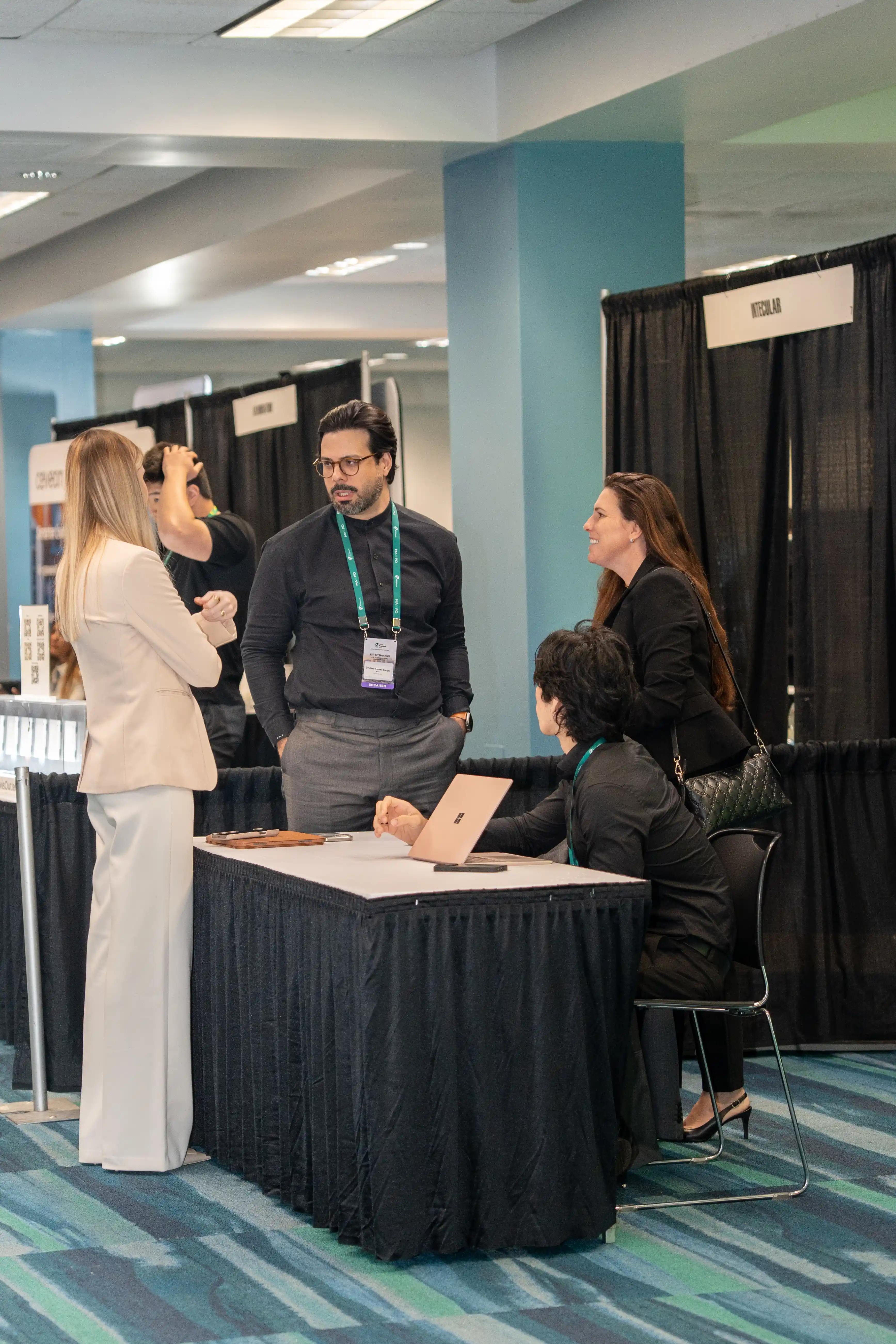 An exhibitor walking delegates through a solution at their stand